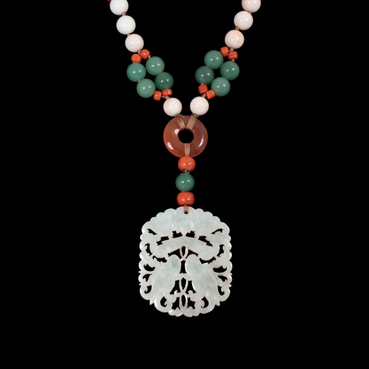 Exquisite Asian-inspired necklace adorned with a intricate white jade pendant.
