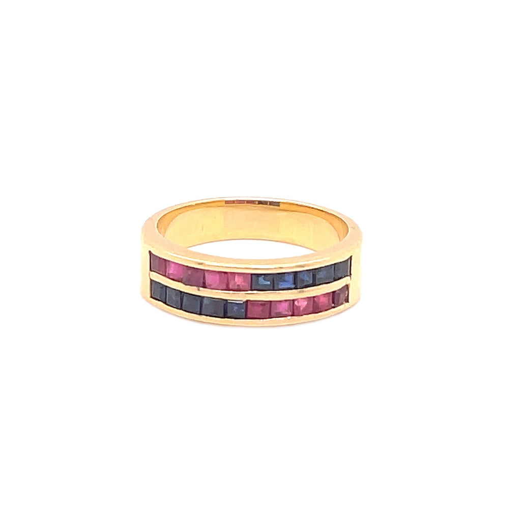 Striking channel-set golden ring with alternating pink and blue gemstones.