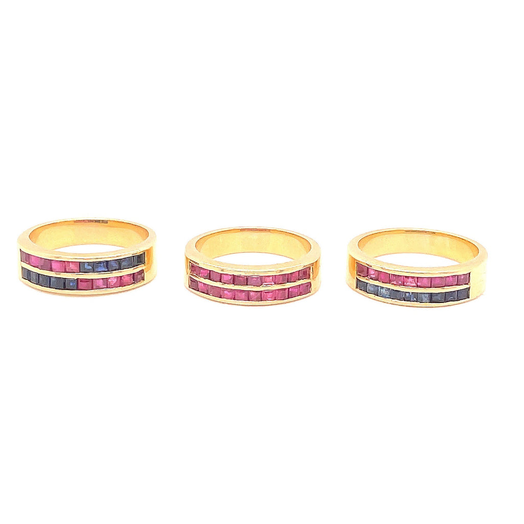 Three exquisite gold rings with channel-set gemstones in vibrant colors.