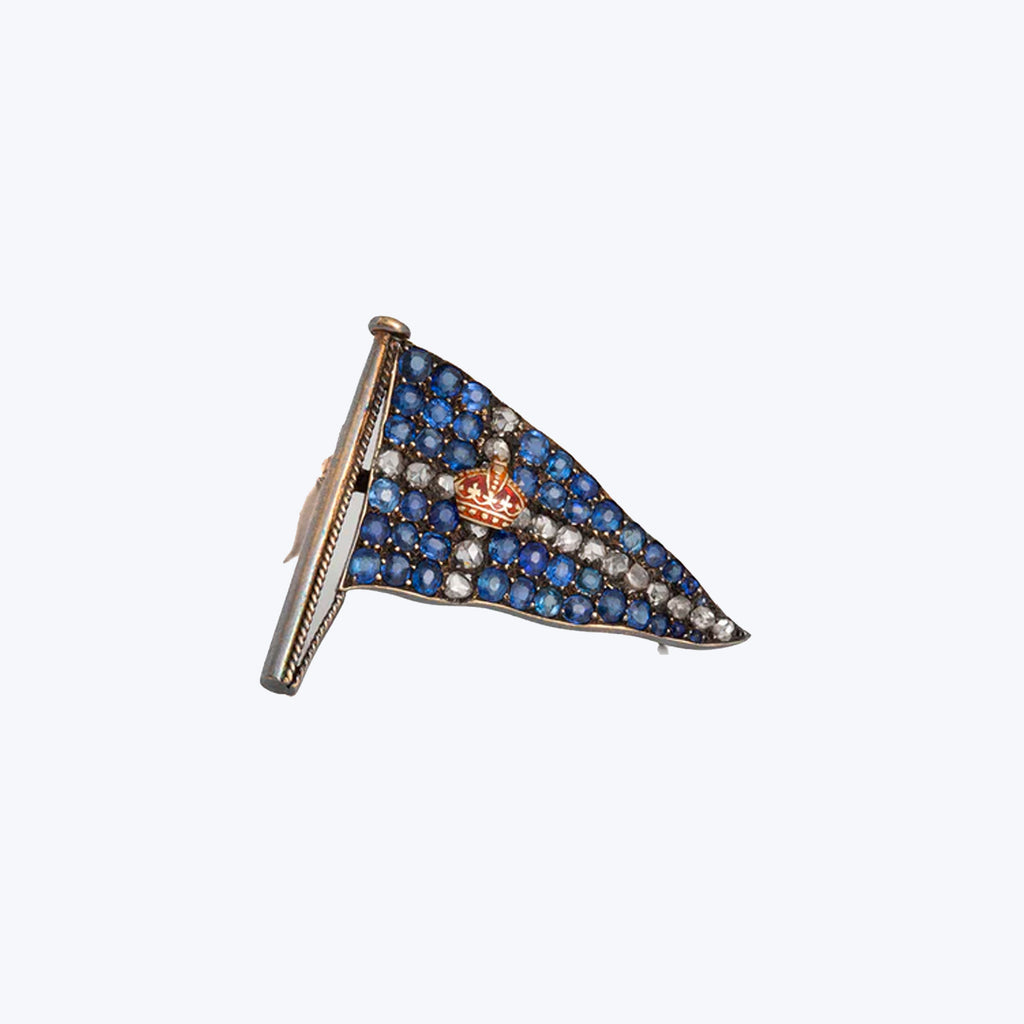 Exquisite royal-themed brooch adorned with blue and white gemstones