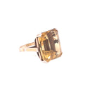 Stunning square-cut gemstone ring in rich yellow-brown hue on metal band.