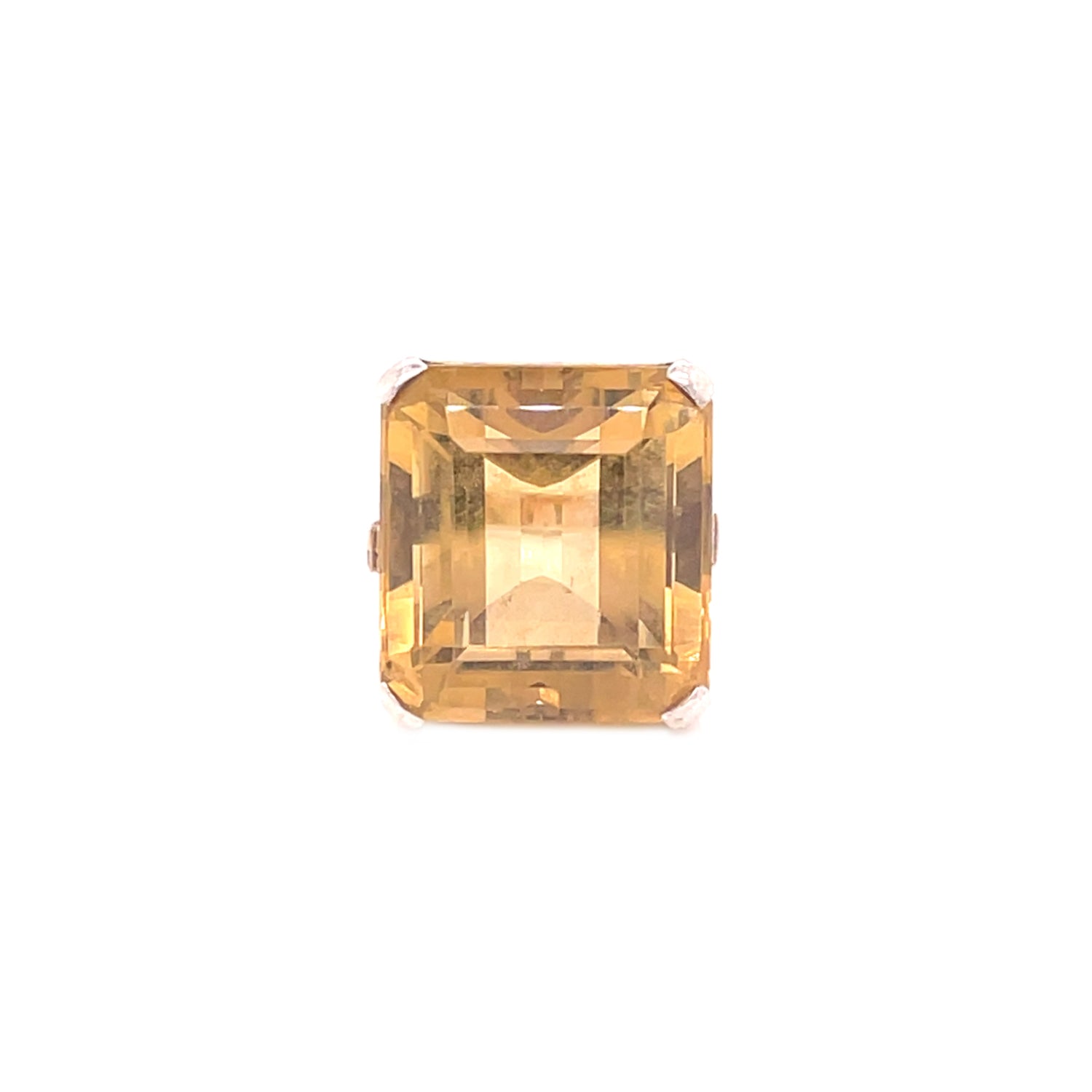 Gorgeous golden-yellow gemstone with an emerald cut on display.