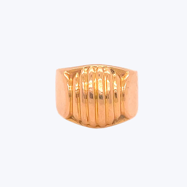 Gold statement ring with etched lines, creating texture and shine.