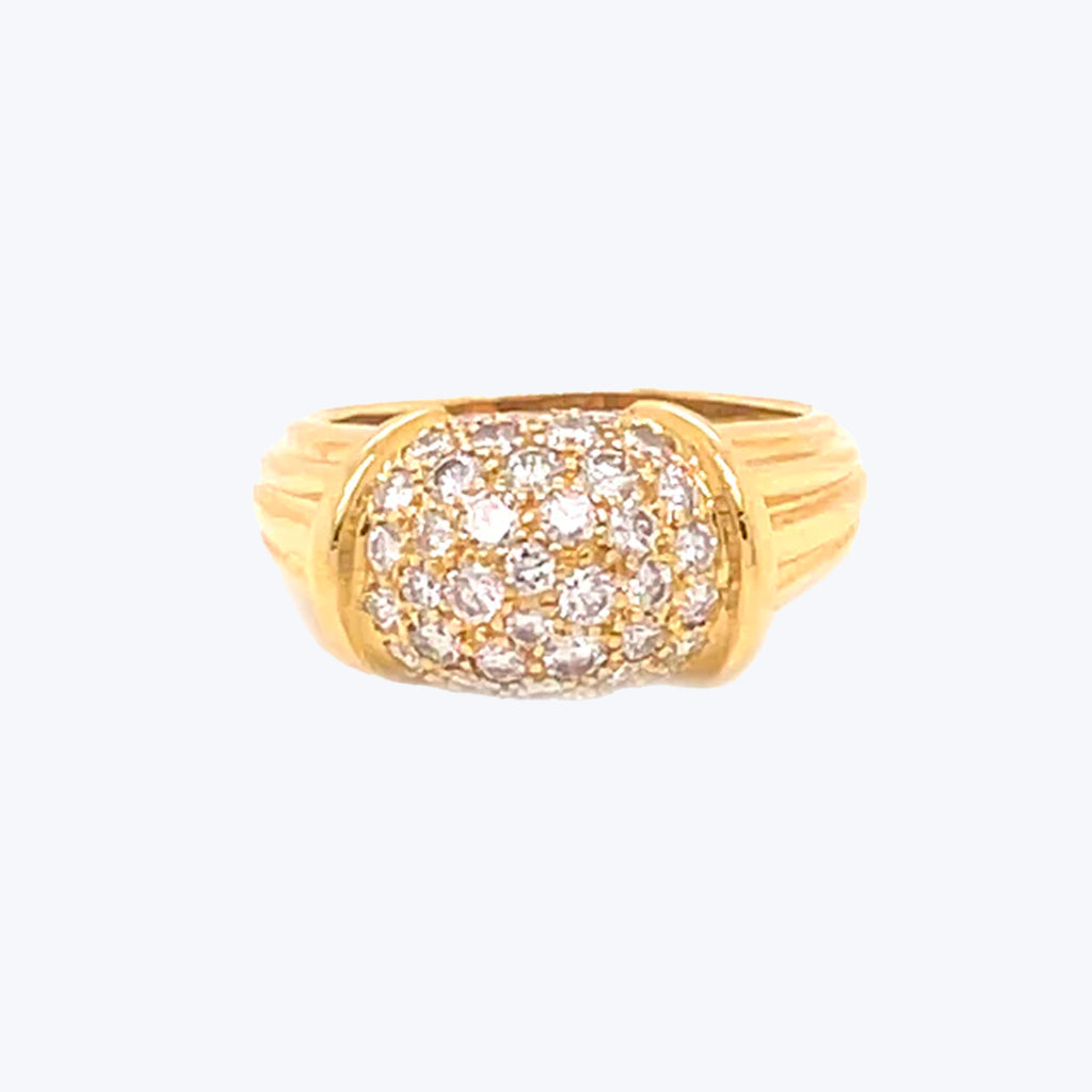 Bold and ornate gold ring with glittering gemstone pave setting