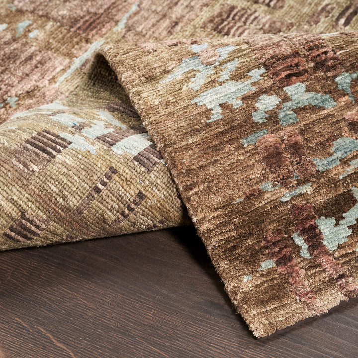 Close-up of plush, multi-colored area rug with modern design.