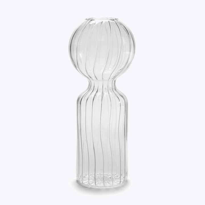 Hourglass-shaped glass vase with vertical ridges on white background.