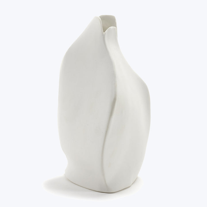 Modern white ceramic vase with asymmetrical form and sculptural design.