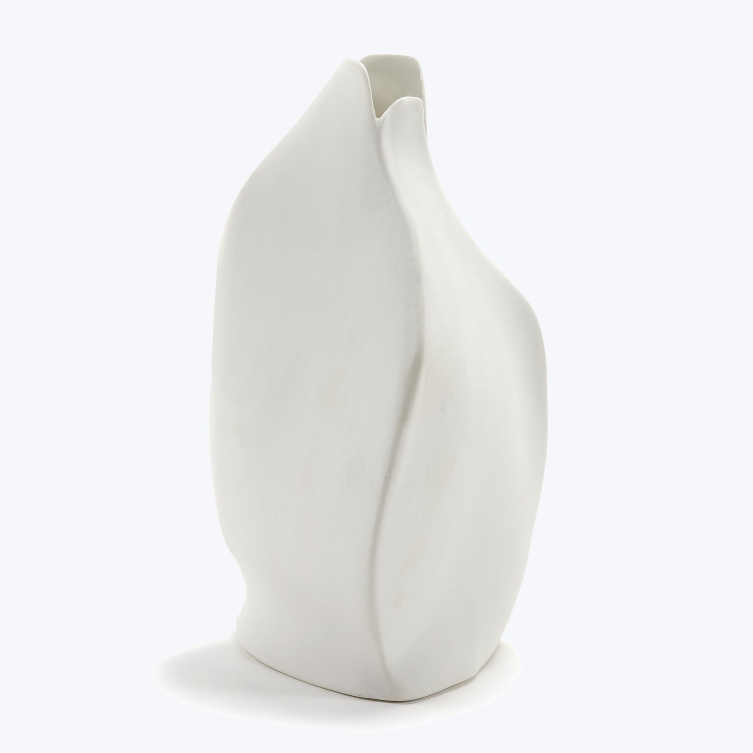 Modern white ceramic vase with asymmetrical form and sculptural design.