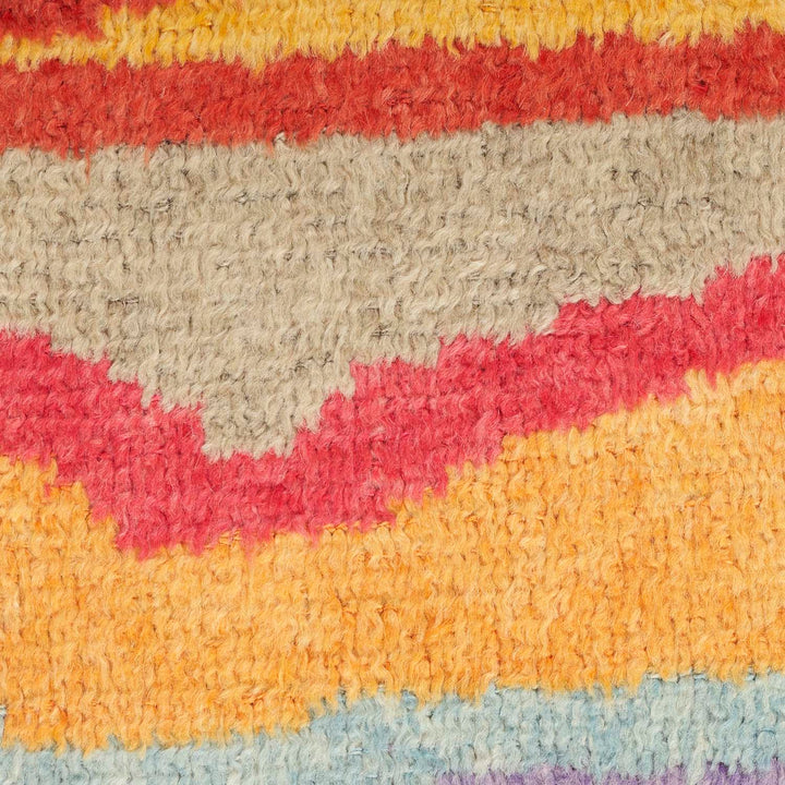 Close-up of multicolored striped rug with fluffy texture and weave pattern.