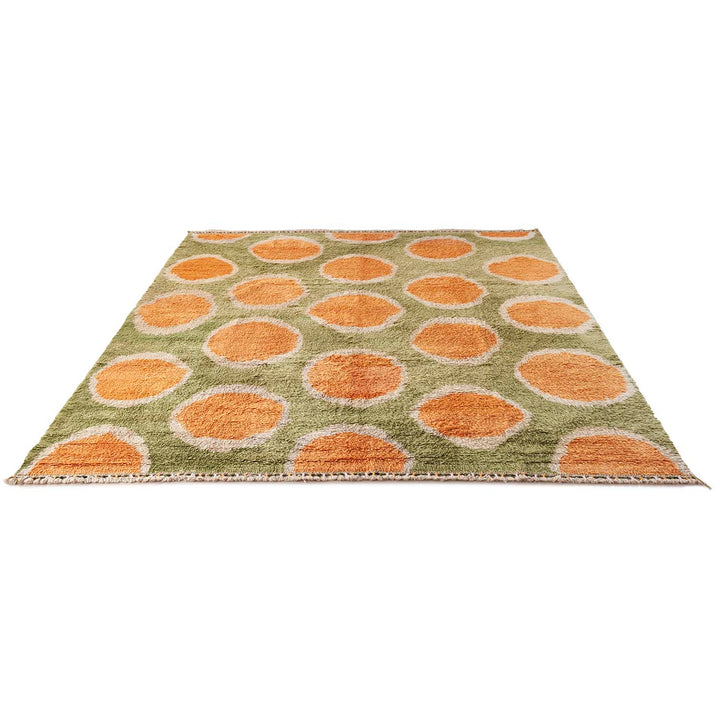Rectangular area rug with abstract spot pattern in earthy tones.