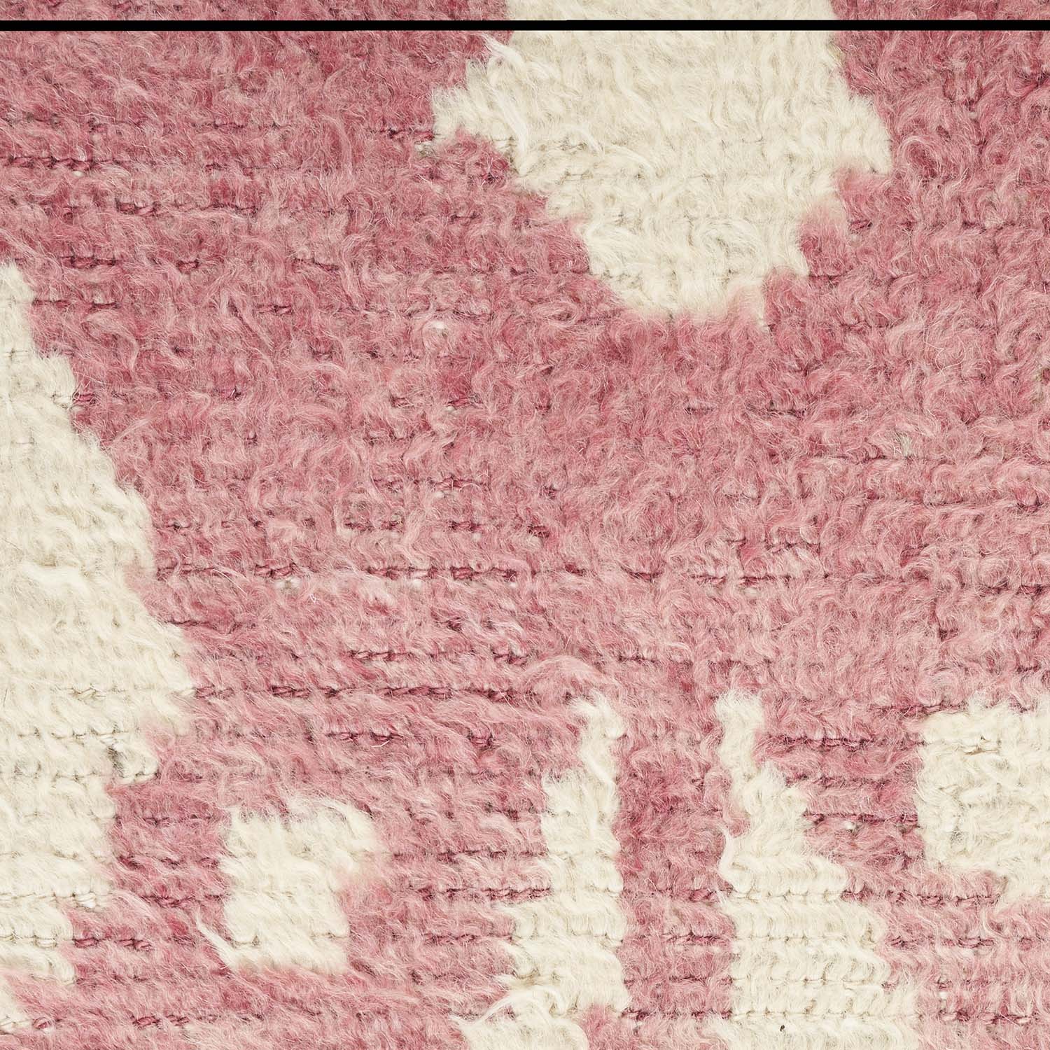 Muted pink textured fabric with fluffy appearance and irregular white patches.