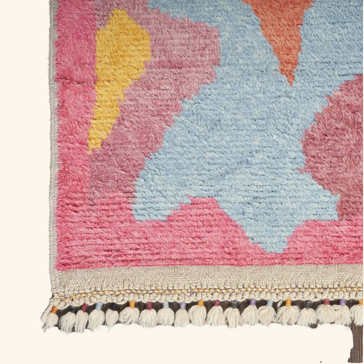 Vibrant, handcrafted area rug with geometric design and textured pile