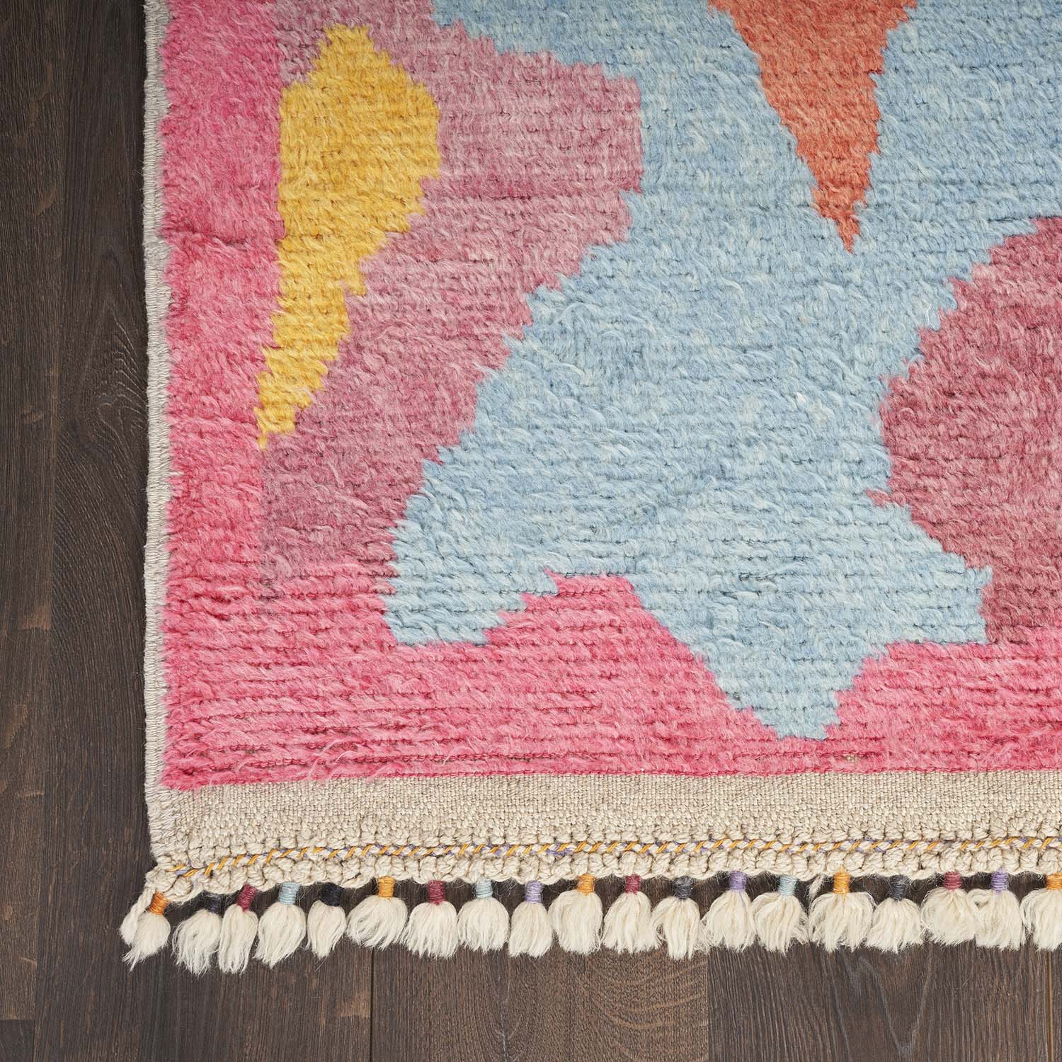 Vibrant, handcrafted area rug with geometric design and textured pile