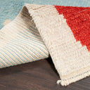 Close-up of textured rug with plush top side and fringe detail.