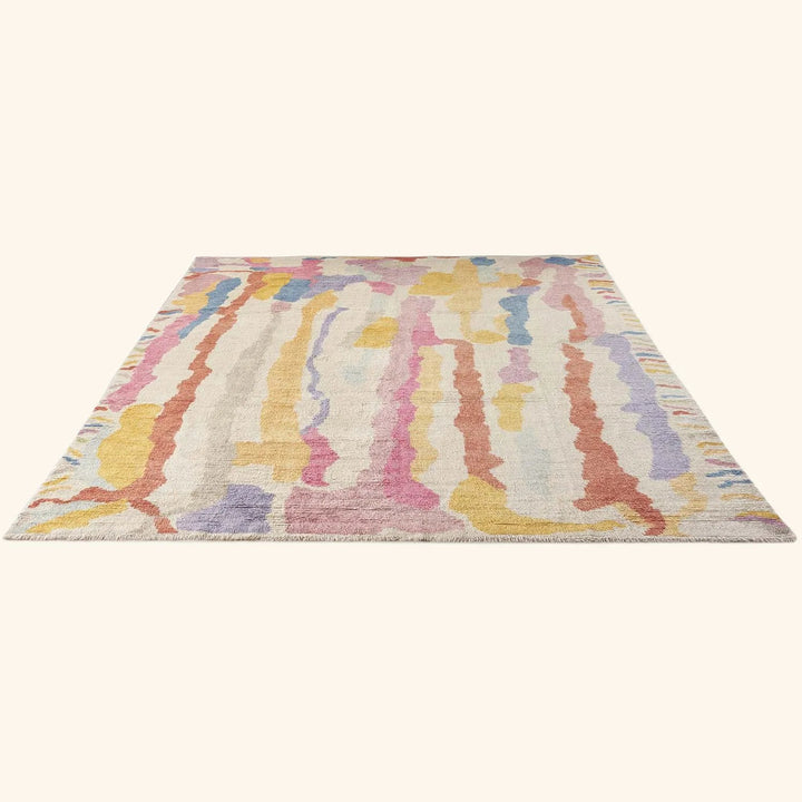 Colorful, abstract area rug with pastel stripes resembles watercolor painting.