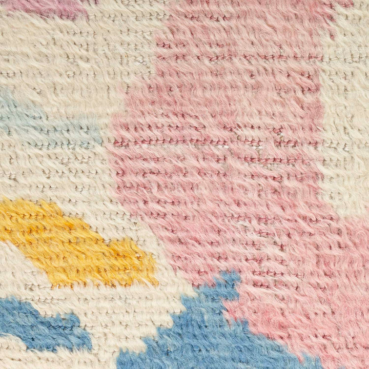 Close-up of a colorful, textured textile showcasing intricate weaving technique.
