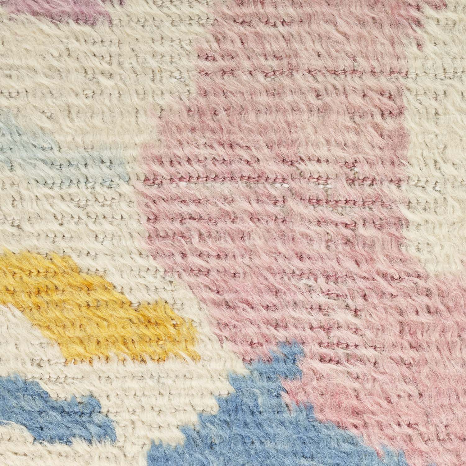 Close-up of a colorful, textured textile showcasing intricate weaving technique.
