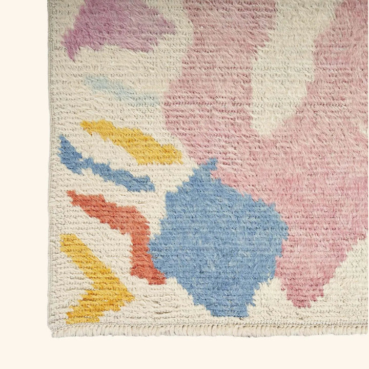 Abstract looped pile rug with pastel colors and textured look.