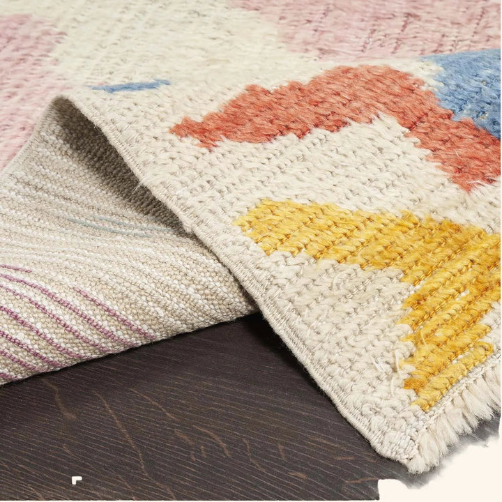 Close-up of a handcrafted rug with vibrant colors and texture.