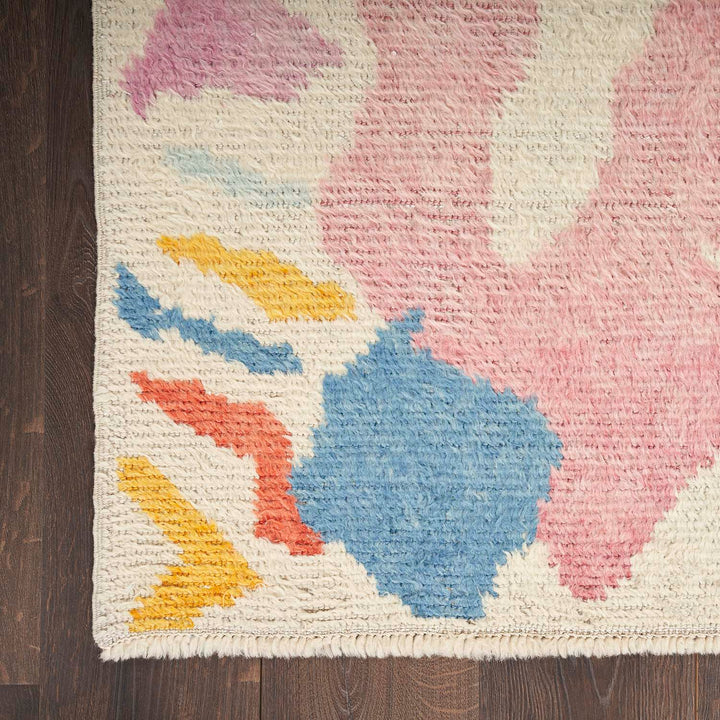 Abstract, multicolored handcrafted rug with plush texture and cozy vibe.