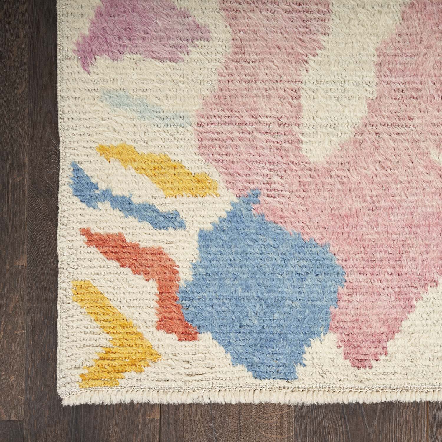 Abstract, multicolored handcrafted rug with plush texture and cozy vibe.