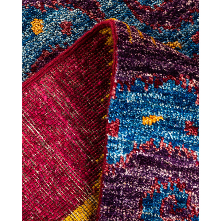 Vibrant, textured fabric with rich patterns in blues and purples.