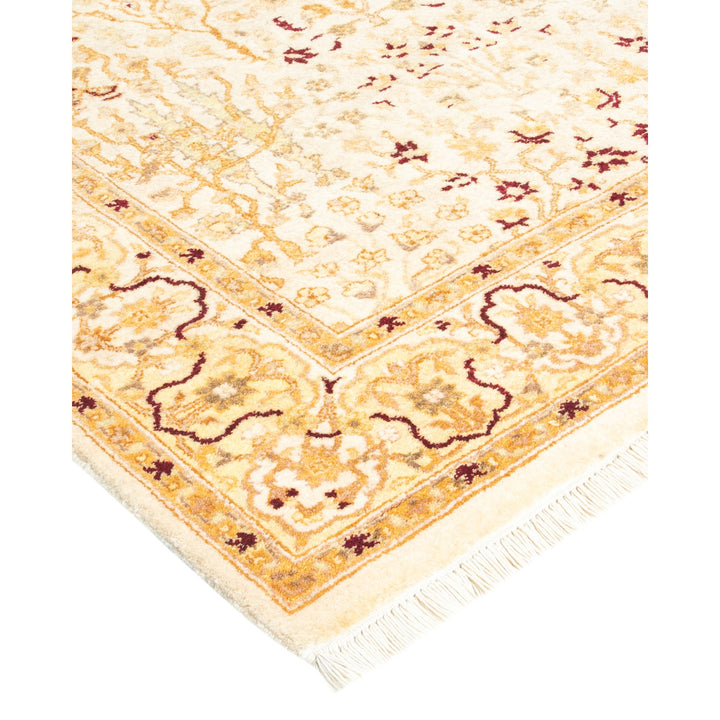 Intricate floral and ornamental rug corner adds elegance to room.