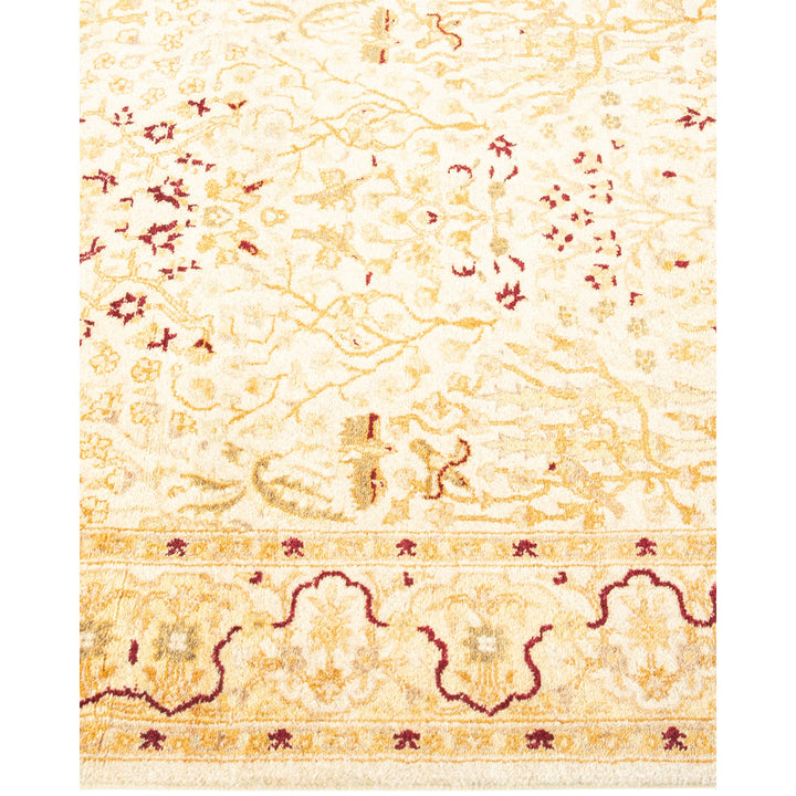 Intricately patterned traditional-style area rug in cream and beige hues.