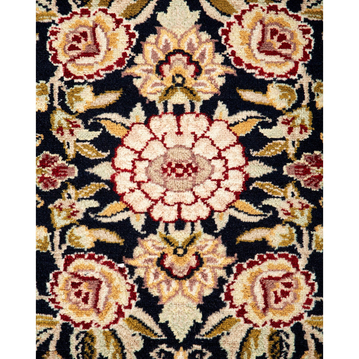 Ornate floral carpet design in vivid colors against dark background.