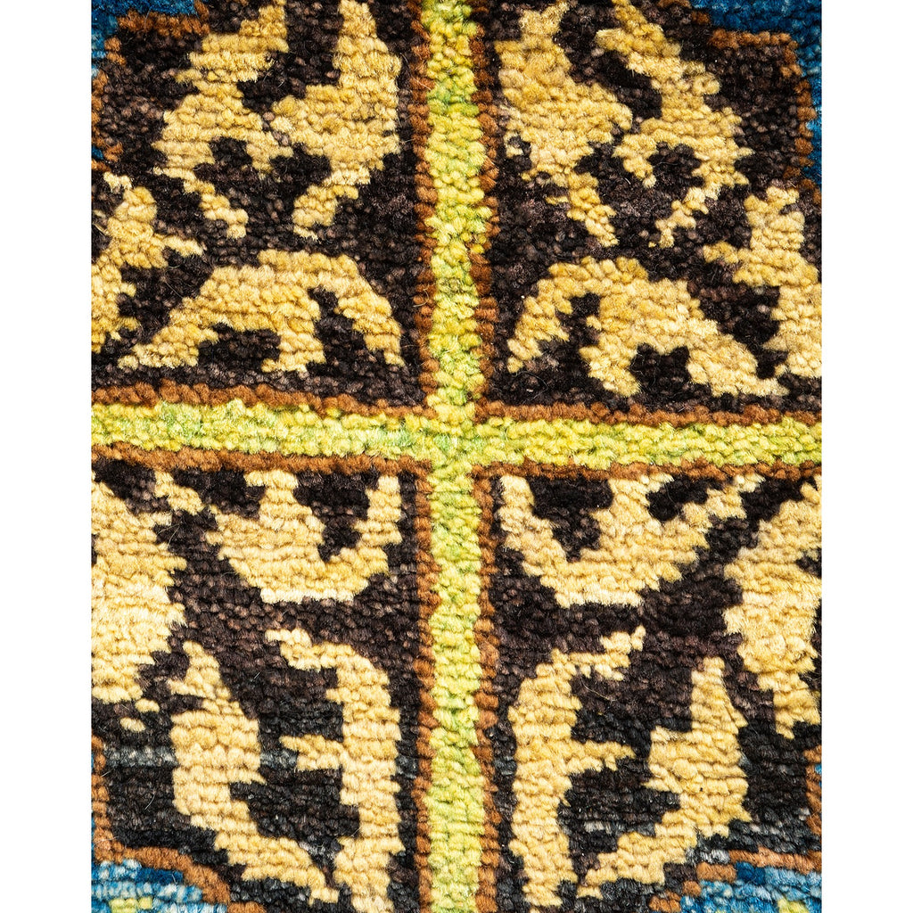 Close-up of a handwoven rug with geometric symmetrical patterns.