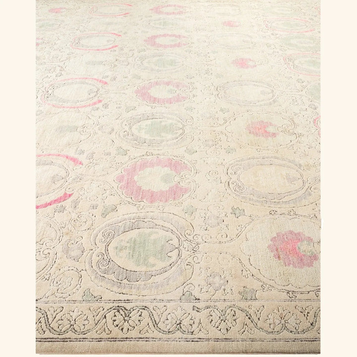 Vintage-inspired carpet with floral medallions in green and pink.