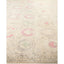 Vintage-inspired carpet with floral medallions in green and pink.