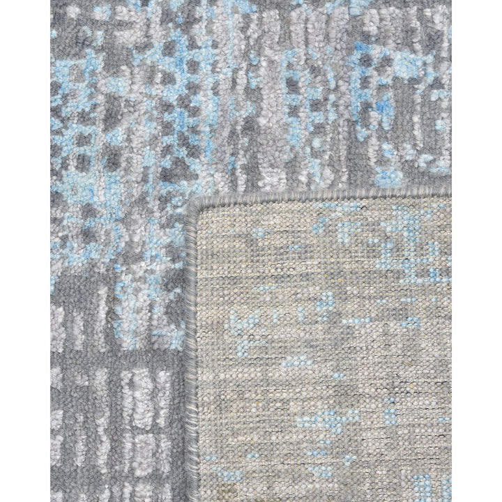 Close-up of a textured fabric with grey and blue tones.
