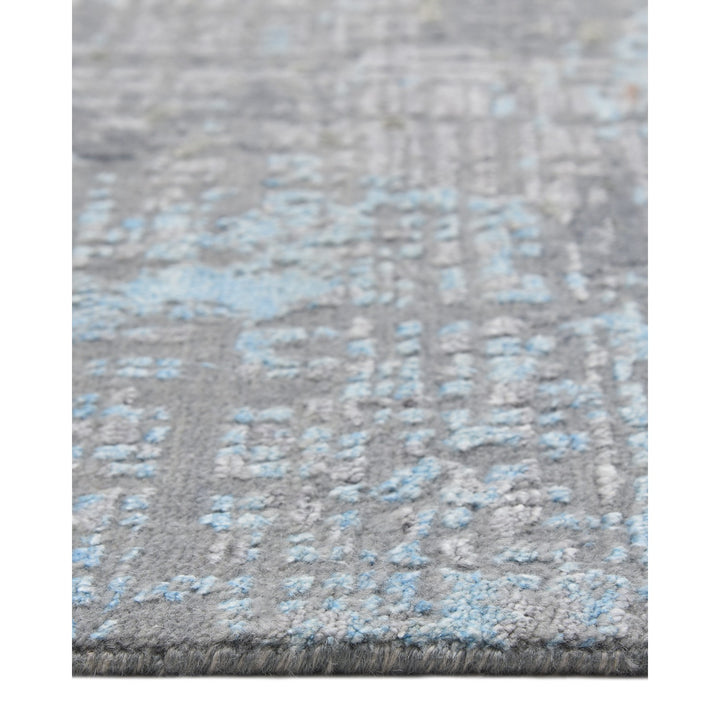 Textured gray rug with intricate patterns and plush fibers.