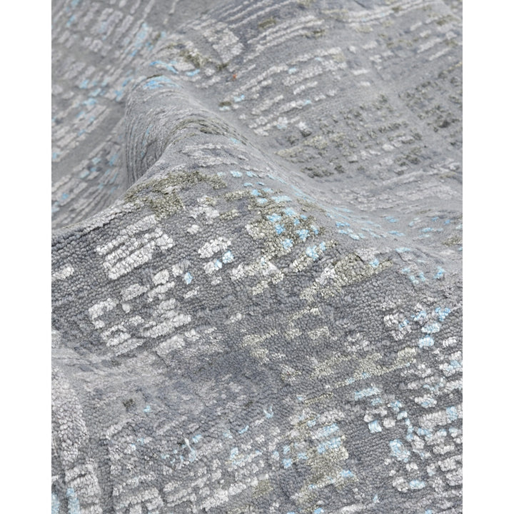 Close-up of a textured fabric in muted shades with blue accents.