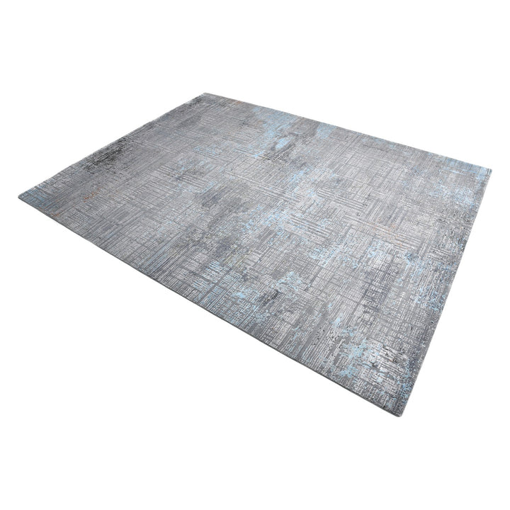 Modern distressed area rug with gray and blue tones showcased.