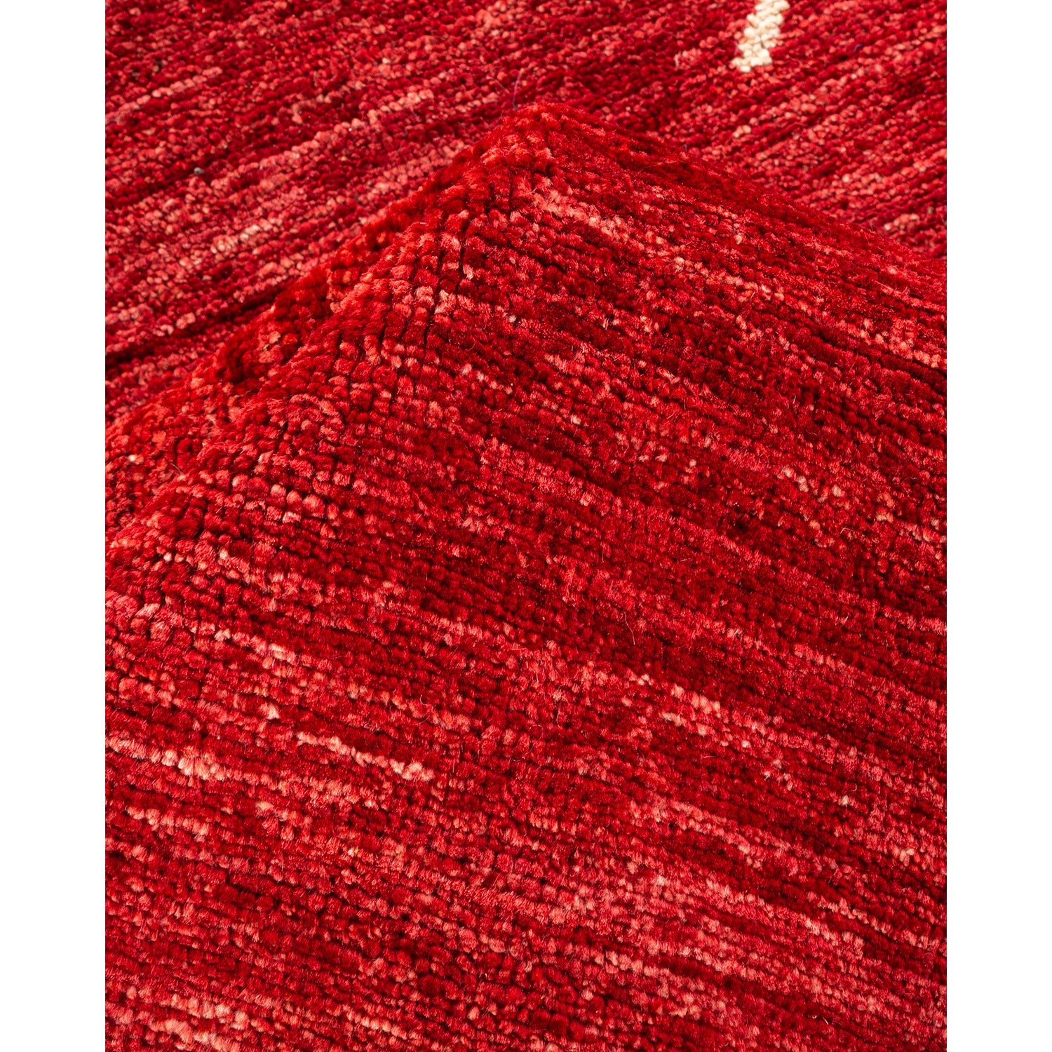 Close-up of a cozy, textured red fabric with irregular knit pattern.