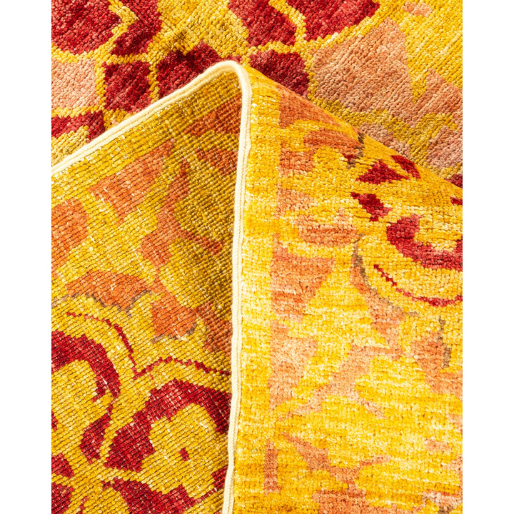 Close-up of a patterned rug with warm tones and intricate design.