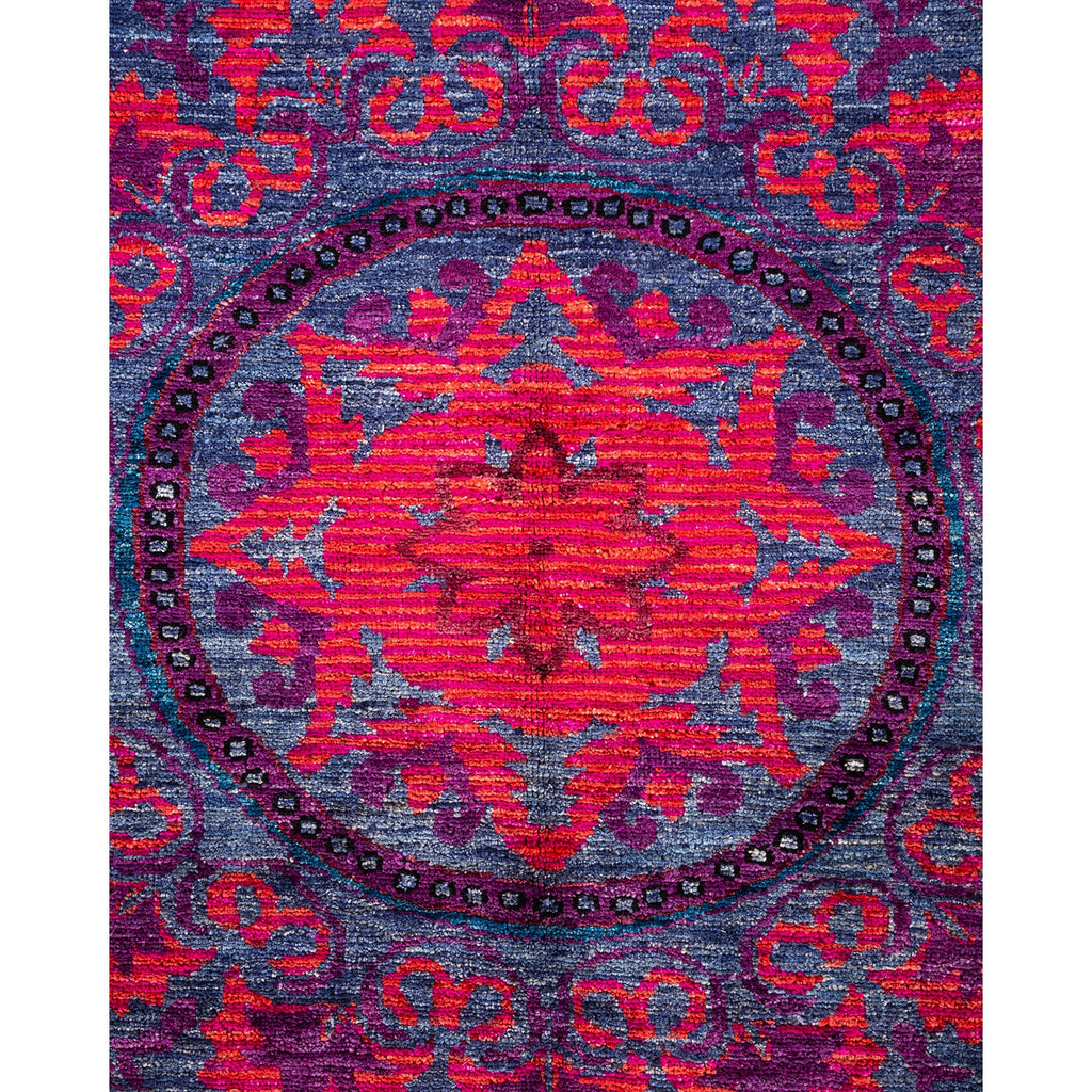 Vibrant rug with intricate symmetrical design and rich colors.