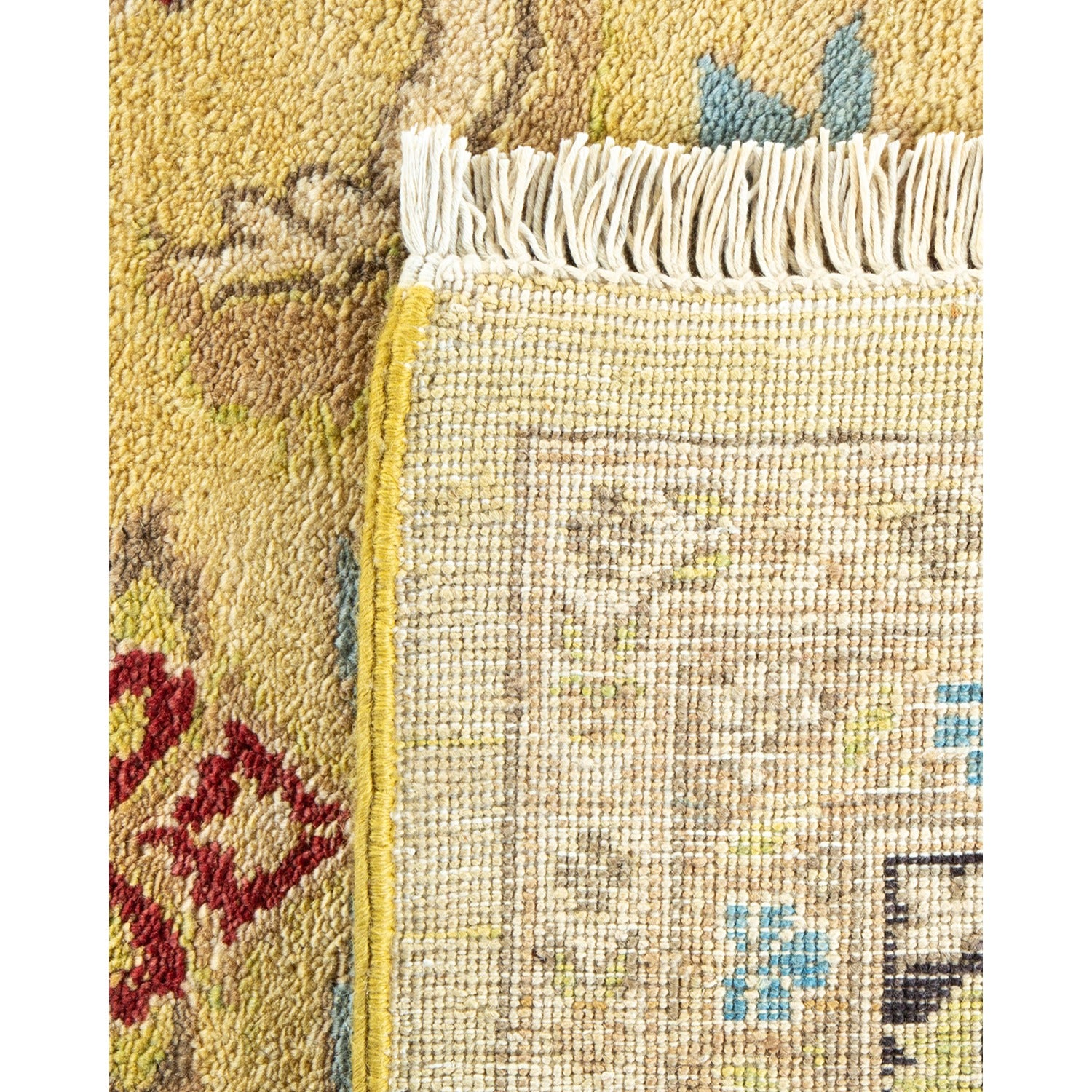 Close-up of a high-quality woven rug with intricate patterns and fringe.