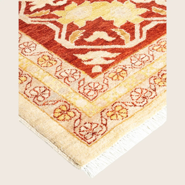 Ornate, warm-colored plush rug with intricate geometric and floral patterns.