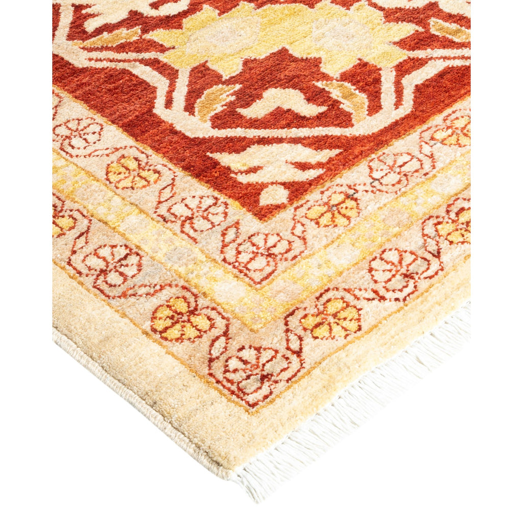 Ornate, warm-colored plush rug with intricate geometric and floral patterns.