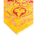 Vibrant, ornate rug with floral-like pattern in warm hues.