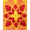 Symmetrical floral and geometric design with vibrant red and yellow hues on a woven rug.