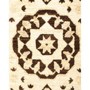 Close-up view of a detailed, symmetrical rug with a Persian-inspired pattern.