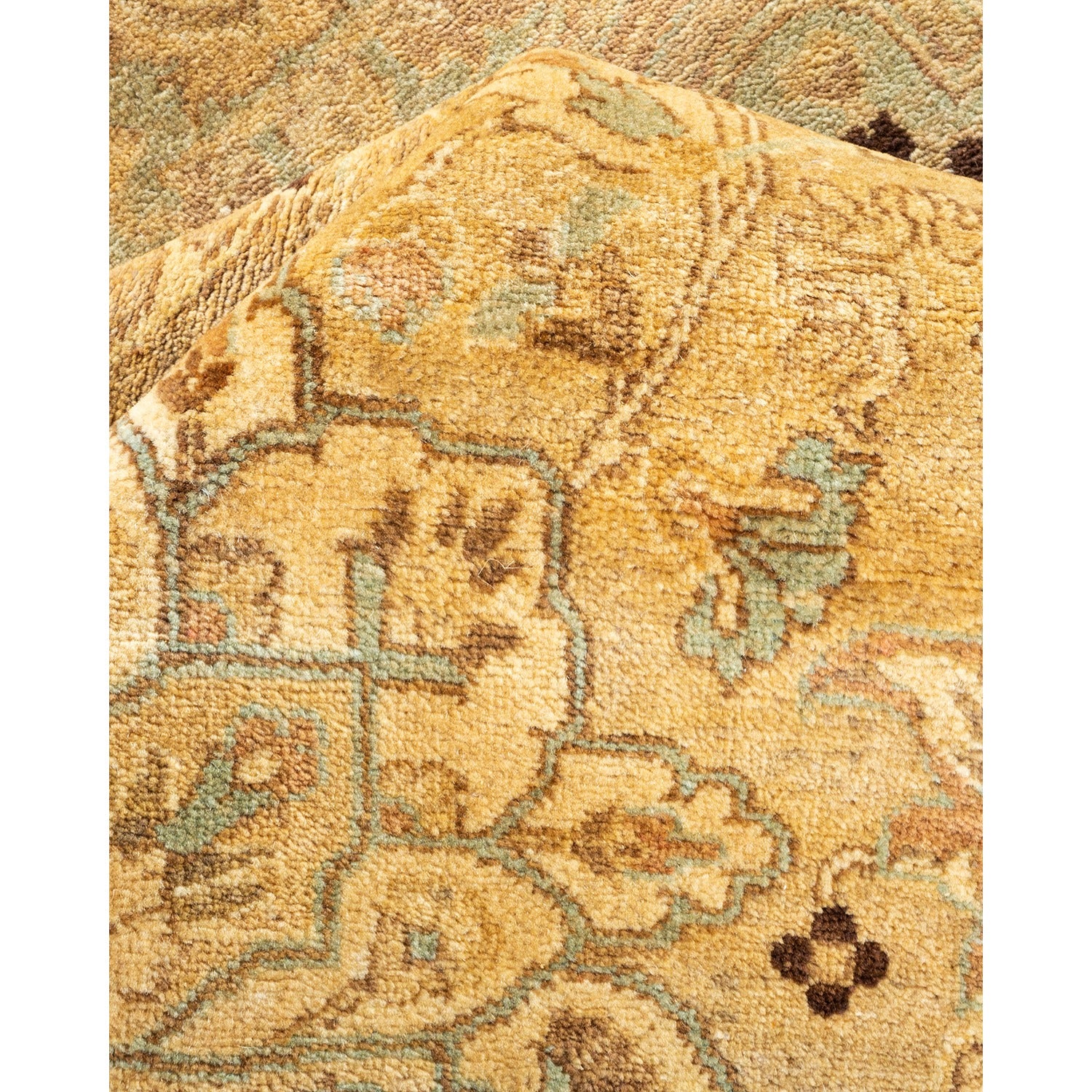 Close-up of a detailed floral patterned carpet in muted colors.