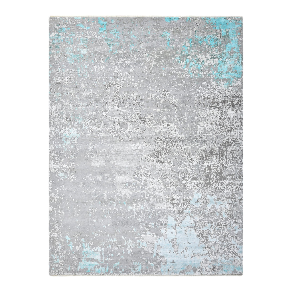Rectangular rug with distressed gray pattern and teal accents.