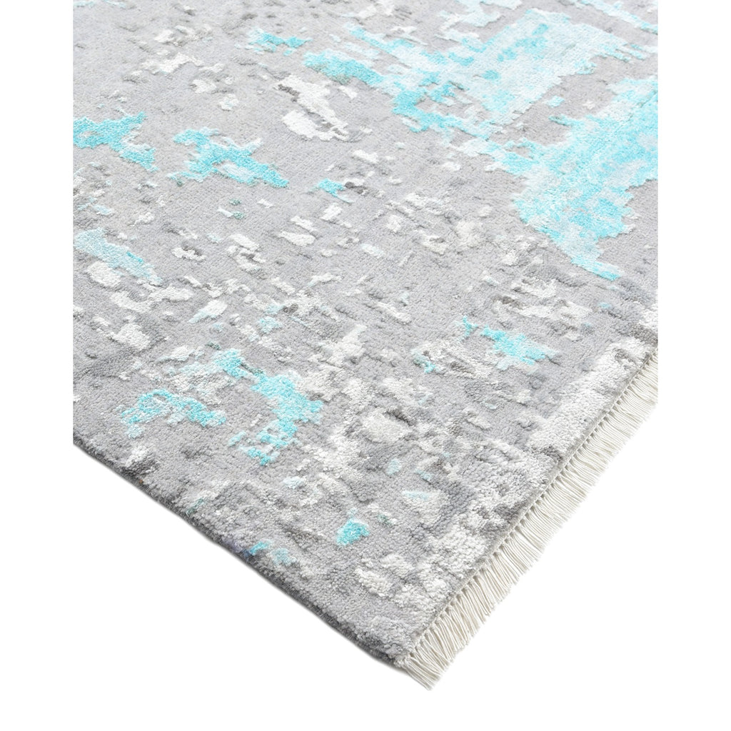 Close-up of a plush, abstract rug with fringed edges.