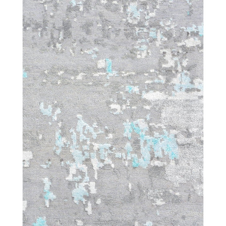 Close-up of abstract textile with soft blue accents on grey background.