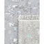 Textured grey rug with subtle blue pattern and artisanal fringe